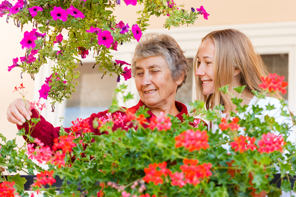 nurse and patient smelling the flowers